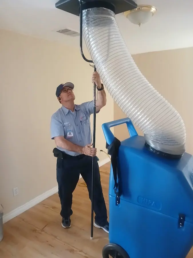 Furnace Tune-Up technician using HEPA equipment in Monitor